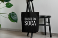 Black canvas tote bag with white Raised on Soca graphic print